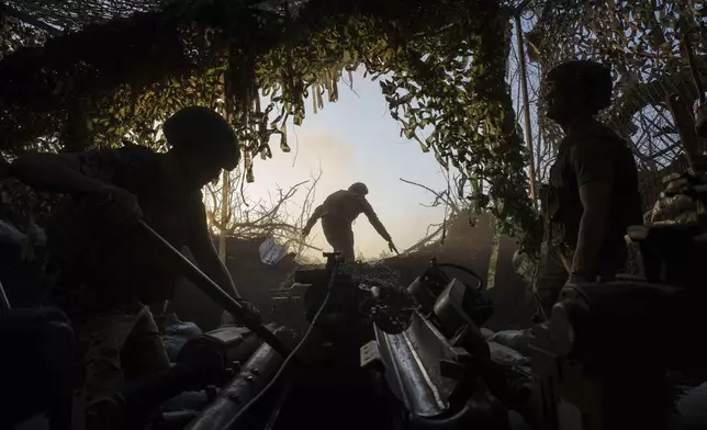 Ukrainian servicemen of 148th separate artillery brigade of the Air Assault Forces prepare a M777 howitzer to fire towards Russian positions at the frontline in Donetsk region, Ukraine, Wednesday, August 21, 2024. (AP Photo/Evgeniy Maloletka)