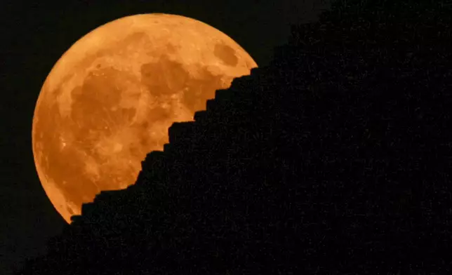 The supermoon rises behind the historical site of Giza Pyramids, near Cairo, Egypt, Monday, Aug. 19, 2024. (AP Photo/Amr Nabil)