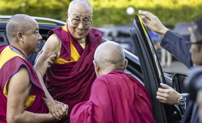 The Dalai Lama arrives at a hotel in Opfikon, outside Zurich, Switzerland, Friday Aug. 23, 2024. (Michael Buholzer/Keystone via AP)