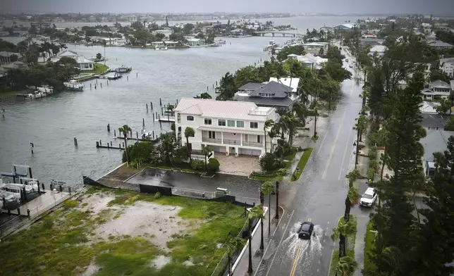 A driver negotiates a flooded street as Tropical Storm Debby passes just to the west of the Tampa Bay, Fla., region, Sunday, Aug. 4, 2024. (Max Chesnes/Tampa Bay Times via AP)