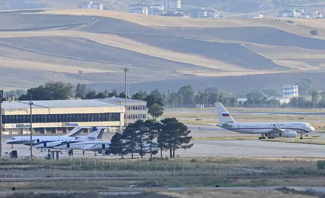 A Russian Plane, right, believed to be carrying released Russian prisoners, moves to take off at the Ankara Airport, Turkey, Thursday, Aug. 1, 2024. (AP Photo)