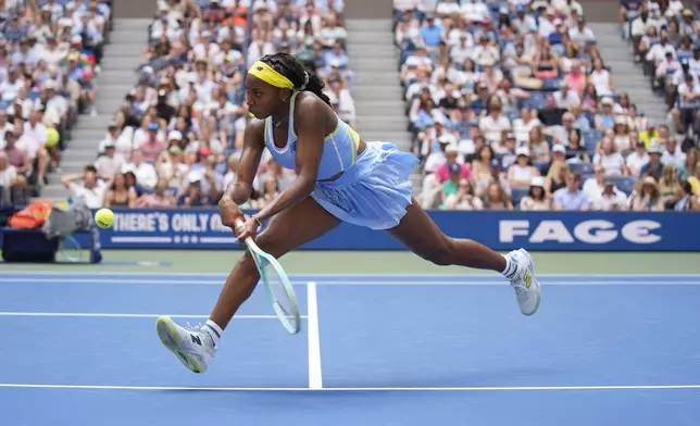 Coco Gauff, of the United States, returns a shot at the net to Varvara Gracheva, of France, during the first round of the U.S. Open tennis championships, Monday, Aug. 26, 2024, in New York. (AP Photo/Seth Wenig)