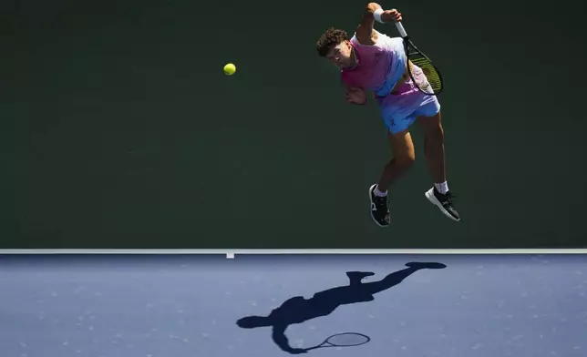 Ben Shelton, of the United States, returns a shot to Dominic Thiem, of Austria, during the first round of the U.S. Open tennis championships, Monday, Aug. 26, 2024, in New York. (AP Photo/Seth Wenig)