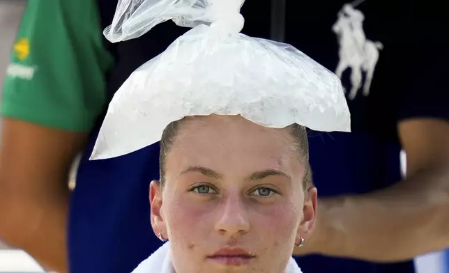 Marta Kostyuk, of Ukraine, cools off with some ice between games against Harriet Dart, of Great Britain, during the second round of the U.S. Open tennis championships, Wednesday, Aug. 28, 2024, in New York. (AP Photo/Kirsty Wigglesworth)