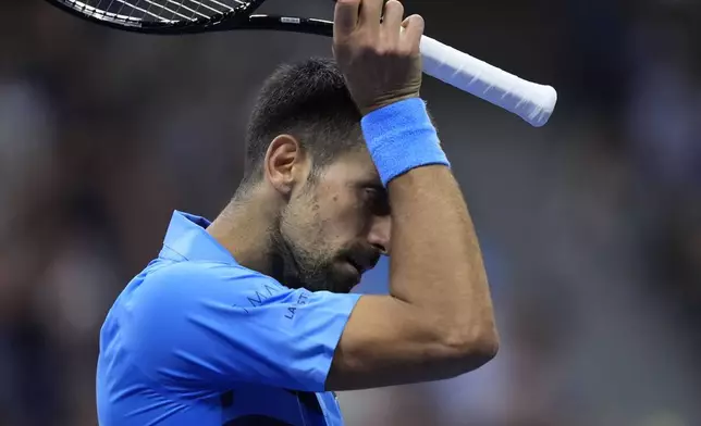 Novak Djokovic, of Serbia, wipes his face against Alexei Popyrin, of Australia, during a third round match of the U.S. Open tennis championships, Friday, Aug. 30, 2024, in New York. (AP Photo/Julia Nikhinson)