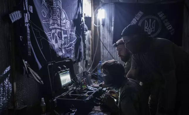 Ukrainian soldiers of 3rd assault brigade fly an FPV exploding drone over Russian positions in Kharkiv region, Ukraine, on Sunday, Aug. 25, 2024. (AP Photo/Evgeniy Maloletka)