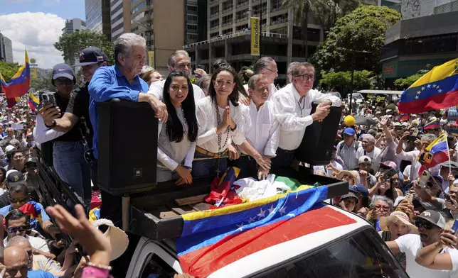 Maria Corina Machado, center, leads a protest against the reelection of President Nicolás Maduro one month after the disputed presidential vote which she claims the opposition won by a landslide, in Caracas, Venezuela, Wednesday, Aug. 28, 2024. (AP Photo/Ariana Cubillos)