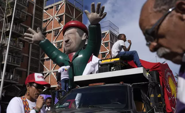 A giant Hugo Chavez balloon towers over supporters before the start of a pro-government rally in Caracas, Venezuela, Saturday, Aug. 3, 2024. (AP Photo/Matias Delacroix)