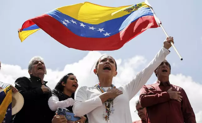 Opposition leader Maria Corina Machado waves a Venezuelan national flag during a rally to protest official results that declared President Nicolas Maduro the winner of the July presidential election, in Caracas, Venezuela, Saturday, Aug. 17, 2024. (AP Photo/Cristian Hernandez)