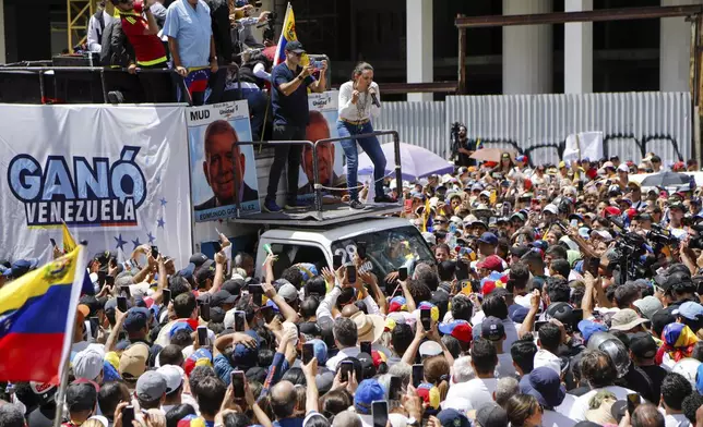 Opposition leader Maria Corina Machado talks to supporters during a rally to protest official results that declared President Nicolas Maduro the winner of the July presidential election, in Caracas, Venezuela, Saturday, Aug. 17, 2024. (AP Photo/Cristian Hernandez)