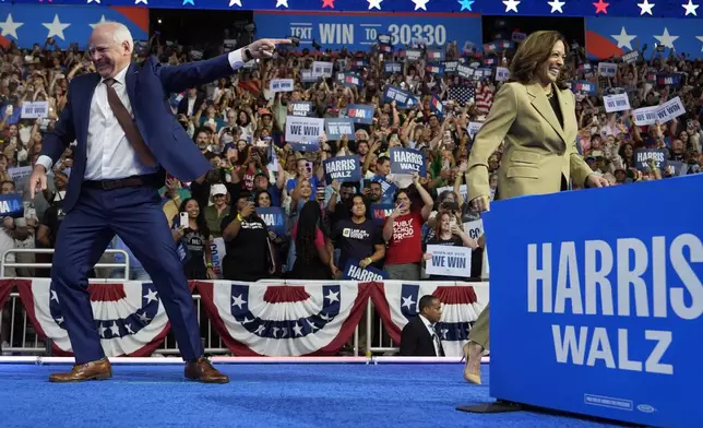 Democratic presidential nominee Vice President Kamala Harris and running mate Minnesota Gov. Tim Walz arrive during a campaign rally at Desert Diamond Arena, Friday, Aug. 9, 2024, in Glendale, Ariz. (AP Photo/Julia Nikhinson)