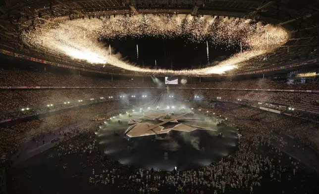 Fireworks ignite during the 2024 Summer Olympics closing ceremony at the Stade de France, Sunday, Aug. 11, 2024, in Saint-Denis, France. (AP Photo/Kin Cheung)