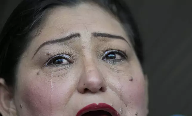 Leticia Torrealba sheds tears as she speaks about the detention of her 16-year-old son Adrian who was detained during a government crackdown in response to anti-government protests that erupted throughout the country after President Nicolas Maduro was declared winner amid allegations of fraud, in Caracas, Venezuela, Thursday, Aug. 15, 2024. Torrealba said her son had not participated in the protests but was picked up by security forces as he walked along a street. (AP Photo/Ariana Cubillos)