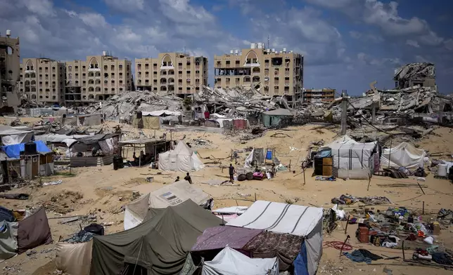 Palestinians displaced by the Israeli air and ground offensive on the Gaza Strip flee from Hamad City, following an evacuation order by the Israeli army to leave parts of the southern area of Khan Younis, Sunday, Aug. 11, 2024. (AP Photo/Abdel Kareem Hana)