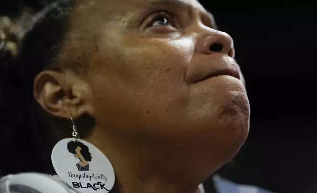 A supporter wearing earrings that read "Unapologetically Black" listens during a campaign rally for Democratic presidential nominee Vice President Kamala Harris, Saturday, Aug. 10, 2024, in Las Vegas. (AP Photo/Julia Nikhinson)