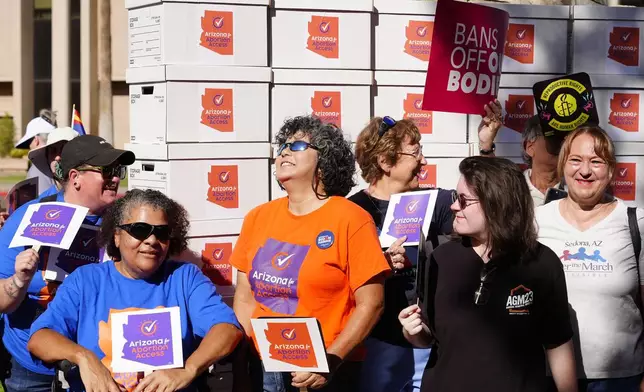 FILE - Arizona abortion-rights supporters gather for a news conference prior to delivering more than 800,000 petition signatures to the state Capitol to get abortion rights on the November general election ballot, July 3, 2024, in Phoenix. (AP Photo/Ross D. Franklin, File)