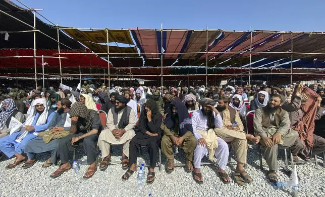 Afghans attend a ceremony to celebrate the third anniversary of the withdrawal of U.S.-led troops from Afghanistan, in Bagram Air Base in the Parwan Province of Afghanistan, Wednesday, Aug. 14, 2024. (AP Photo/Siddiqullah Alizai)