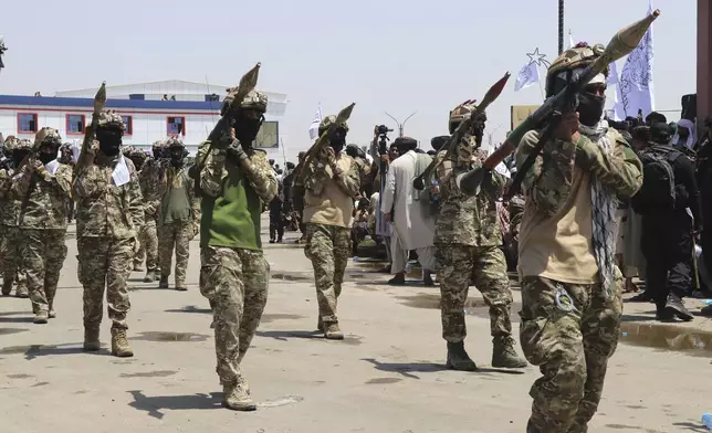 Taliban fighters carry rocket launchers as they celebrate the third anniversary of the withdrawal of US-led troops from Afghanistan, in Lashkar Gah, Helmand province, southwestern Afghanistan, Wednesday, Aug. 14, 2024. (AP Photo/Abdul Khaliq)