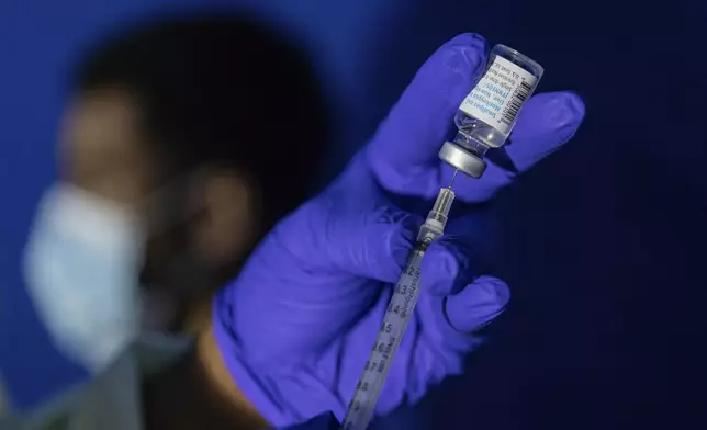 FILE - Family nurse practitioner Carol Ramsubhag-Carela prepares a syringe with the Mpox vaccine before inoculating a patient at a vaccinations site on, Aug. 30, 2022, in the Brooklyn borough of New York. (AP Photo/Jeenah Moon, File)