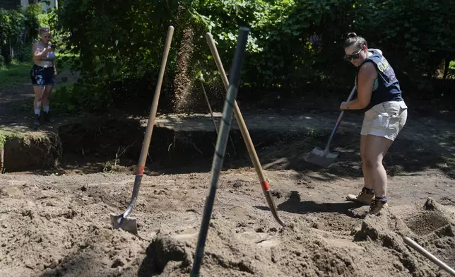 Students including Maddy Thomas, right, work at the site of an African burial ground in Kingston, N.Y., Monday, Aug. 5, 2024. (AP Photo/Seth Wenig)