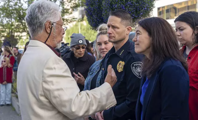 Rev. Samuel Unutoa speaks with Mayor Suzanne LaFrance and Police Chief Sean Case during a march for Easter Leafa, a 16-year-old recently fatally shot by police, on Saturday, Aug. 17, 2024, outside the police headquarters in Anchorage, Alaska. (Loren Holmes