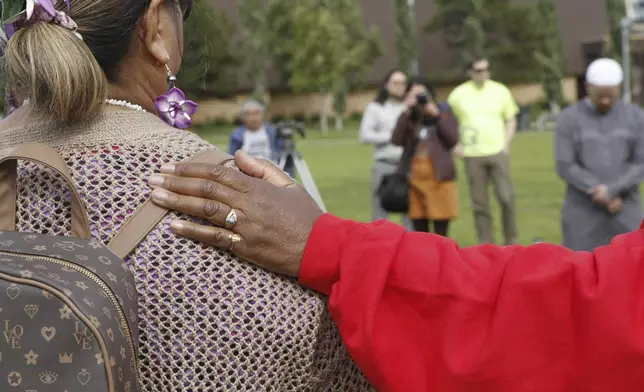 Rev. Patricia A. Wilson Cone, right, of First American Baptist Church, right, puts her hand on the shoulder of Lusiana Hansen, executive director of the Polynesian Association of Alaska, during a prayer vigil Friday, Aug. 16, 2024, in downtown Anchorage, Alaska, after police shot and killed 16-year-old Easter Leafa, who had recently moved from American Samoa. (AP Photo/Mark Thiessen)