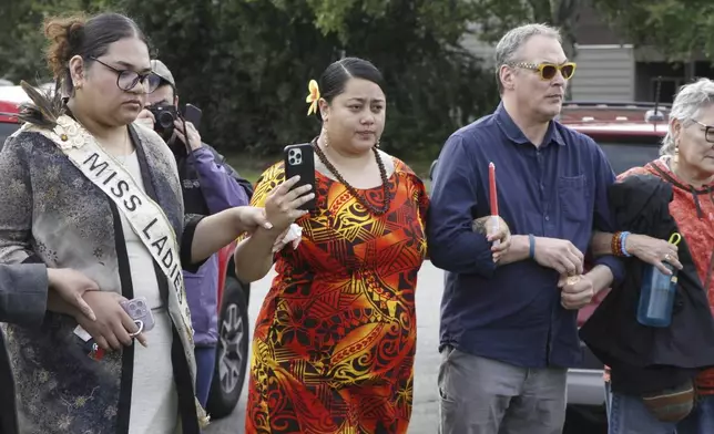 A prayer vigil drew about 100 residents, including members of the American Samoa community, to downtown Anchorage, Alaska, on Friday, Aug. 16, 2024, after police shot and killed 16-year-old Easter Leafa. (AP Photo/Mark Thiessen)