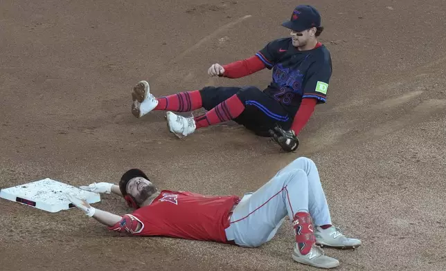 Los Angeles Angels Nolan Schanuel is out at second base by Toronto Blue Jays short stop Ernie Clement during first inning of a baseball game in Toronto, Friday, Aug. 23, 2024. (Chris Young/The Canadian Press via AP)