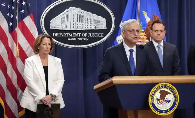 Attorney General Merrick Garland, center, speaks with reporters about an antitrust lawsuit against real estate software company RealPage during a news conference at the Department of Justice, Friday, Aug. 23, 2024, in Washington. At left is Deputy Attorney General Lisa Monaco and at right is Acting Associate Attorney General Benjamin Mizer. (AP Photo/Mark Schiefelbein)