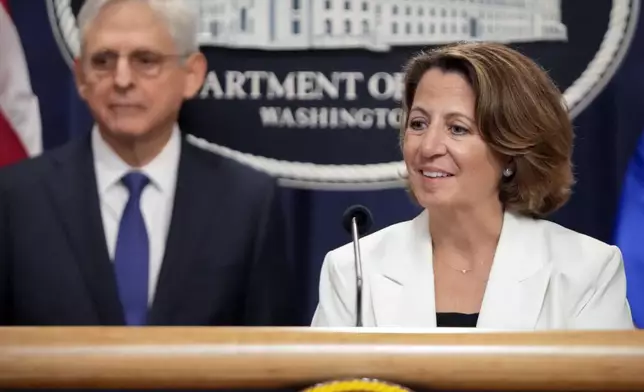 Deputy Attorney General Lisa Monaco speaks with reporters about an antitrust lawsuit against real estate software company RealPage during a news conference at the Department of Justice, Friday, Aug. 23, 2024, in Washington. At left is Attorney General Merrick Garland. (AP Photo/Mark Schiefelbein)