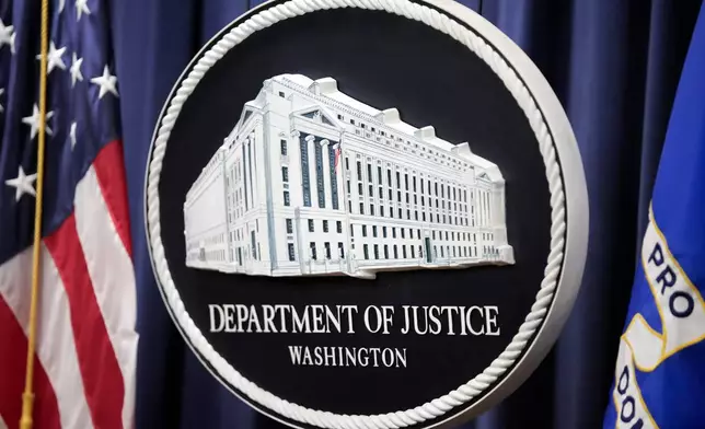 The logo for the Justice Department is seen before a news conference at the Department of Justice, Friday, Aug. 23, 2024, in Washington. (AP Photo/Mark Schiefelbein)