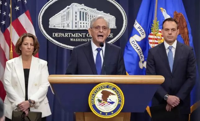 Attorney General Merrick Garland, center, speaks with reporters about an antitrust lawsuit against real estate software company RealPage during a news conference at the Department of Justice, Friday, Aug. 23, 2024, in Washington. At left is Deputy Attorney General Lisa Monaco and at right is Acting Associate Attorney General Benjamin Mizer. (AP Photo/Mark Schiefelbein)