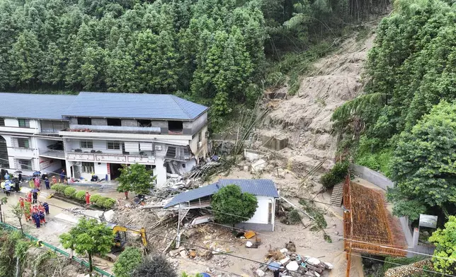 FILE - In this drone photo released by Xinhua News Agency, a landslide destroys a house in Yuelin village of Shouyue town of Hengyang city, central China's Hunan Province on July 28, 2024. (Chen Zhenhai/Xinhua via AP, File)