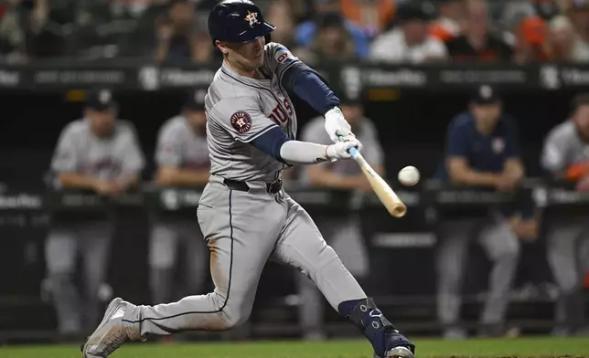 Houston Astros' Alex Bregman hits a solo home run against Baltimore Orioles pitcher Burch Smith during the seventh inning of a baseball game, Sunday, Aug. 25, 2024, in Baltimore. (AP Photo/Terrance Williams)