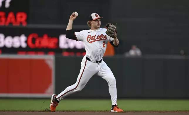 Baltimore Orioles shortstop Gunnar Henderson throws to first base for an out on a ball hit by Houston Astros' Yainer Diaz during the first inning of a baseball game, Sunday, Aug. 25, 2024, in Baltimore. (AP Photo/Terrance Williams)