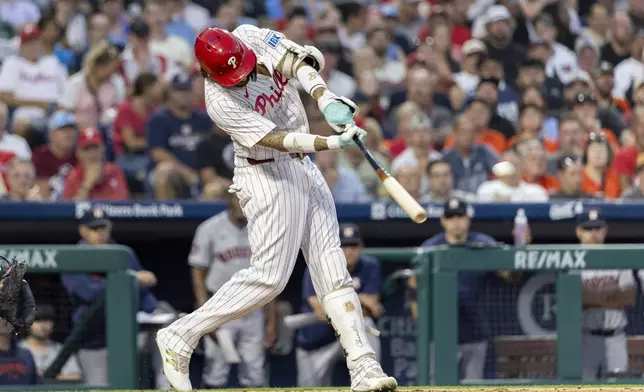 Philadelphia Phillies' Nick Castellanos hits a three run homer in the third inning of a baseball game against the Houston Astros, Tuesday, Aug. 27, 2024, in Philadelphia. (AP Photo/Laurence Kesterson)