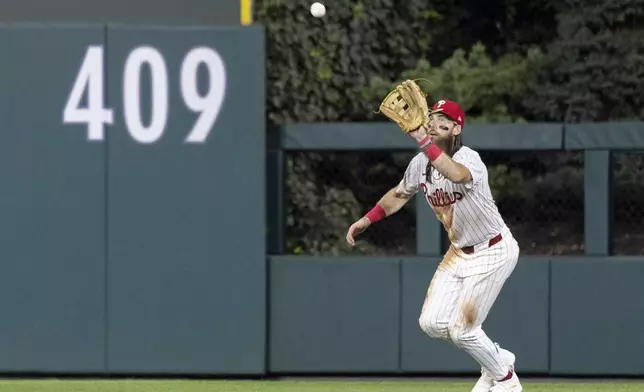 Philadelphia Phillies outfielder Brandon Marsh catches a fly from Houston Astros Mauricio Dubón in the fifth inning of a baseball game, Tuesday, Aug. 27, 2024, in Philadelphia. (AP Photo/Laurence Kesterson)