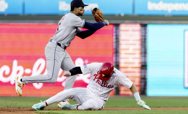 Philadelphia Phillies' Bryce Harper is out at second as Houston Astros shortstop Jeremy Pena throws to first for a double play in the first inning of a baseball game, Tuesday, Aug. 27, 2024, in Philadelphia. (AP Photo/Laurence Kesterson)