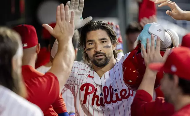 Philadelphia Phillies' Nick Castellanos is cheered in the dugout after hitting a three run homer in the third inning of a baseball game against the Houston Astros, Tuesday, Aug. 27, 2024, in Philadelphia. (AP Photo/Laurence Kesterson)