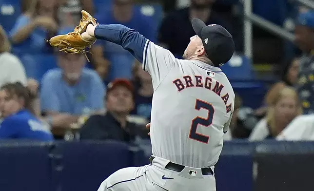 Houston Astros third baseman Alex Bregman makes a leaping catch on a pop foul by Tampa Bay Rays' Josh Lowe during the fifth inning of a baseball game Tuesday, Aug. 13, 2024, in St. Petersburg, Fla. (AP Photo/Chris O'Meara)