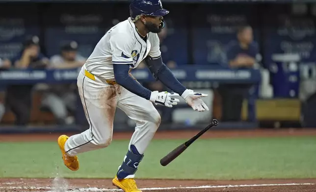 Tampa Bay Rays' Junior Caminero drops his bat after hitting a single off Houston Astros starting pitcher Yusei Kikuchi during the fourth inning of a baseball game Tuesday, Aug. 13, 2024, in St. Petersburg, Fla. (AP Photo/Chris O'Meara)