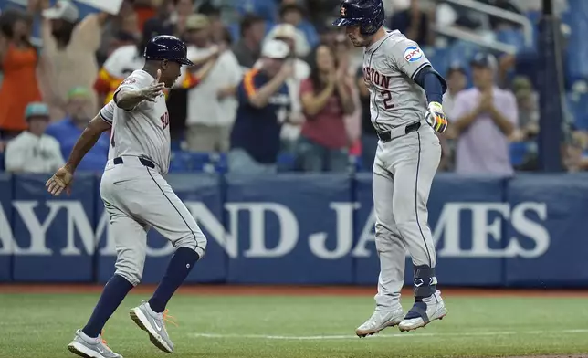 Houston Astros' Alex Bregman (2) celebrates with third base coach Gary Pettis after hitting a solo home run offTampa Bay Rays starting pitcher Shane Baz during the fifth inning of a baseball game Tuesday, Aug. 13, 2024, in St. Petersburg, Fla. (AP Photo/Chris O'Meara)