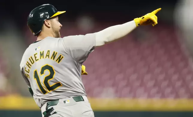 Oakland Athletics' Max Schuemann celebrates his home run against the Cincinnati Reds during the seventh inning of a baseball game, Tuesday, Aug. 27, 2024, in Cincinnati. (AP Photo/Jay LaPrete)