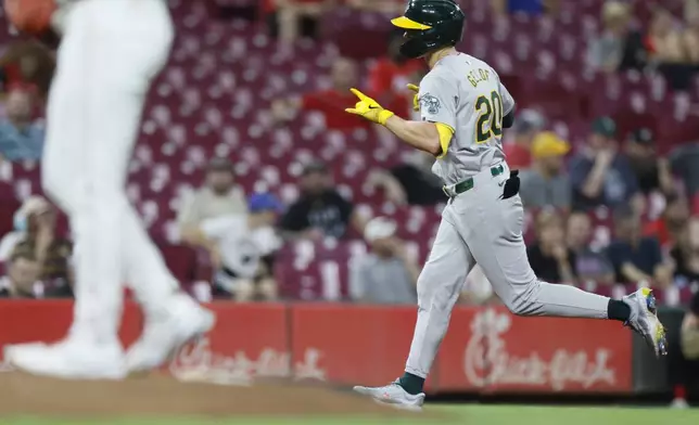 Oakland Athletics' Zack Gelof celebrates his home run against the Cincinnati Reds during the eighth inning of a baseball game Tuesday, Aug. 27, 2024, in Cincinnati. (AP Photo/Jay LaPrete)