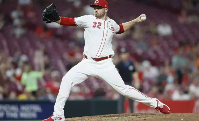 Cincinnati Reds relief pitcher Justin Wilson throws against the Oakland Athletics during the seventh inning of a baseball game, Tuesday, Aug. 27, 2024, in Cincinnati. (AP Photo/Jay LaPrete)