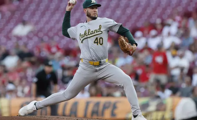 Oakland Athletics starting pitcher Mitch Spence throws against the Cincinnati Reds during the first inning of a baseball game, Tuesday, Aug. 27, 2024, in Cincinnati. (AP Photo/Jay LaPrete)