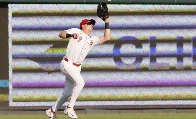 Cincinnati Reds left fielder Spencer Steer catches a fly ball hit by Oakland Athletics' JJ Bleday during the first inning of a baseball game, Tuesday, Aug. 27, 2024, in Cincinnati. (AP Photo/Jay LaPrete)