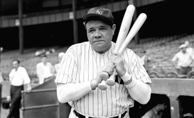 FILE - Retired Yankees slugger Babe Ruth warms up with three bats before stepping to the plate at New York's Yankee Stadium, August 21, 1942. (AP Photo/Tom Sande, File)