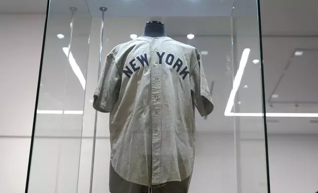 The 1932 Babe Ruth game worn New York Yankees World Series "Called Shot" jersey is displayed in a sealed glass box at Heritage Auction in Irving, Texas, Wednesday, Aug. 21, 2024. (AP Photo/LM Otero)