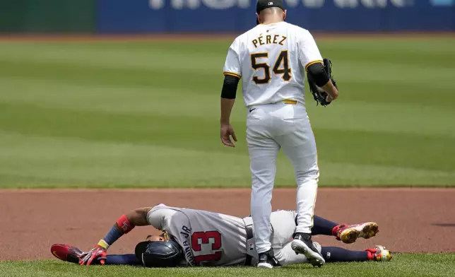 FILE - Pittsburgh Pirates starting pitcher Martín Pérez (54) checks on Atlanta Braves' Ronald Acuña Jr., who injured himself running the bases during the first inning of a baseball game against the Pittsburgh Pirates in Pittsburgh, Sunday, May 26, 2024. (AP Photo/Gene J. Puskar, File)